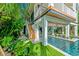 Elevated home with wooden staircase leading to the pool at 2208 Avenue A, Bradenton Beach, FL 34217