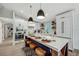Modern kitchen featuring white cabinets, a large island, and stainless steel appliances at 2208 Avenue A, Bradenton Beach, FL 34217