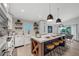 Modern kitchen with white cabinets, a large island, and quartz countertops at 2208 Avenue A, Bradenton Beach, FL 34217