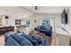 Open living space with comfortable navy sofas and a modern kitchen at 2208 Avenue A, Bradenton Beach, FL 34217