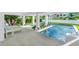 Covered patio features lounge chairs and pool access at 2208 Avenue A, Bradenton Beach, FL 34217