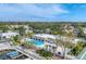 Aerial view of community pool, clubhouse, and marina at 2605 Riverbluff Pkwy # V142, Sarasota, FL 34231