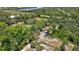 Aerial view showing home, lush vegetation, and a tranquil waterway in the background at 29199 Livingston Dr, Punta Gorda, FL 33982