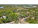 Aerial view of property showcasing home, surrounding trees, and a scenic waterfront at 29199 Livingston Dr, Punta Gorda, FL 33982