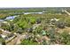 Aerial view of home nestled in a wooded area near a waterway at 29199 Livingston Dr, Punta Gorda, FL 33982