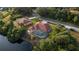 Aerial view showing two houses and a pool, situated by a waterway at 2960 Nimbus Dr, North Port, FL 34287