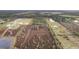 Aerial view of a large property with various buildings, fields, and wetlands at 39200 Cook Brown Rd, Punta Gorda, FL 33982