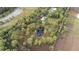 Aerial view showing home, pond, and surrounding land at 39200 Cook Brown Rd, Punta Gorda, FL 33982