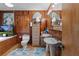 Bathroom with double pedestal sinks, wood-paneled walls, and a vintage feel at 39200 Cook Brown Rd, Punta Gorda, FL 33982