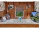 Bathroom with a built in tub and wood paneling, a large TV, and various decor at 39200 Cook Brown Rd, Punta Gorda, FL 33982