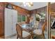 Dining area with a glass table, wicker chairs, and white storage cabinet at 39200 Cook Brown Rd, Punta Gorda, FL 33982