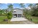 Elevated home with carport and stairs leading to the entrance at 39200 Cook Brown Rd, Punta Gorda, FL 33982