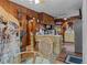 Cozy kitchen features wood paneling, built-in appliances, and a breakfast bar at 39200 Cook Brown Rd, Punta Gorda, FL 33982