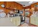 Cozy kitchen with wood cabinets and modern appliances at 39200 Cook Brown Rd, Punta Gorda, FL 33982
