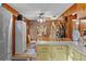 Cozy kitchen with wood cabinets and a dining area at 39200 Cook Brown Rd, Punta Gorda, FL 33982