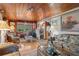 Spacious living room with wood paneling, comfortable seating, and large windows at 39200 Cook Brown Rd, Punta Gorda, FL 33982