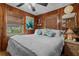 Bright bedroom with wood-paneled walls and a view at 39200 Cook Brown Rd, Punta Gorda, FL 33982