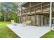 Spacious patio with seating area and elevated home in background at 39200 Cook Brown Rd, Punta Gorda, FL 33982