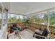 Screened porch overlooks a pond and features comfortable seating at 39200 Cook Brown Rd, Punta Gorda, FL 33982