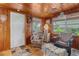 Sunroom with wood paneling, wicker chairs, and access to the outdoors at 39200 Cook Brown Rd, Punta Gorda, FL 33982