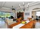 Open dining room with hardwood floors, a wooden table, and access to the living room at 4422 Legacy Ct, Sarasota, FL 34241