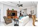 Living room with hardwood floors, comfortable seating, and built-in shelving at 4422 Legacy Ct, Sarasota, FL 34241