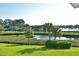 Stunning waterfront view with lush landscaping and palm trees at 4511 Lexington Cir, Bradenton, FL 34210