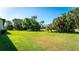 Spacious backyard with lush lawn and mature trees at 4532 Longwater Chase # 37, Sarasota, FL 34235