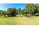 Green lawn with palm trees and natural landscaping at 4532 Longwater Chase # 37, Sarasota, FL 34235