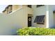 Condo building entrance with lush landscaping at 4532 Longwater Chase # 37, Sarasota, FL 34235