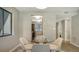 Bright dining area with glass table and four chairs, view of kitchen and hallway at 4532 Longwater Chase # 37, Sarasota, FL 34235