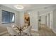 Charming dining area with glass table and four chairs, looking toward kitchen at 4532 Longwater Chase # 37, Sarasota, FL 34235