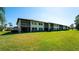 Back exterior showing condo building and lawn at 4532 Longwater Chase # 37, Sarasota, FL 34235