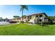 Ground-level condo building with manicured lawn and parking at 4532 Longwater Chase # 37, Sarasota, FL 34235