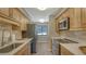 Modern kitchen with stainless steel appliances and light wood cabinets at 4532 Longwater Chase # 37, Sarasota, FL 34235