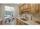 Modern kitchen with stainless steel appliances and light wood cabinets at 4532 Longwater Chase # 37, Sarasota, FL 34235