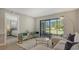 Living room with view into bedroom and patio at 4532 Longwater Chase # 37, Sarasota, FL 34235