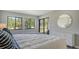 Main bedroom with a king-size bed, sliding doors to patio, and large windows at 4532 Longwater Chase # 37, Sarasota, FL 34235