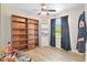 Well-lit bedroom with built-in shelves and wood-look floors at 4820 Sunday Ct, Sarasota, FL 34235