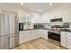 Updated kitchen featuring stainless steel appliances and white cabinetry at 4820 Sunday Ct, Sarasota, FL 34235