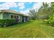 Expansive backyard featuring a lush lawn, screened-in porch, and mature landscaping at 5097 Faberge Pl, Sarasota, FL 34233