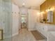 Well-lit bathroom features a walk-in shower, double sinks, and gold hardware accents at 5097 Faberge Pl, Sarasota, FL 34233