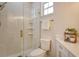 Bright bathroom features a walk-in shower with shelving, marble floors, and gold hardware accents at 5097 Faberge Pl, Sarasota, FL 34233