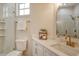 Bright bathroom features a walk-in shower, marble countertops, and gold hardware accents at 5097 Faberge Pl, Sarasota, FL 34233