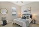 Bright bedroom with cool tones features neutral carpet, art, and a bright window at 5097 Faberge Pl, Sarasota, FL 34233