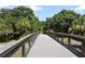 Scenic walkway bridge surrounded by lush greenery and trees, providing a peaceful outdoor experience at 5097 Faberge Pl, Sarasota, FL 34233