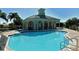 Inviting community pool with a clubhouse and ample lounge chairs at 5097 Faberge Pl, Sarasota, FL 34233