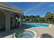 Community pool and hot tub surrounded by a spacious deck and poolside seating at 5097 Faberge Pl, Sarasota, FL 34233