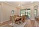 Dining area featuring modern chandelier, natural light, and access to the patio at 5097 Faberge Pl, Sarasota, FL 34233
