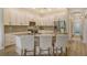 Modern kitchen featuring white cabinetry, stainless steel appliances, and granite countertops with bar seating at 5097 Faberge Pl, Sarasota, FL 34233